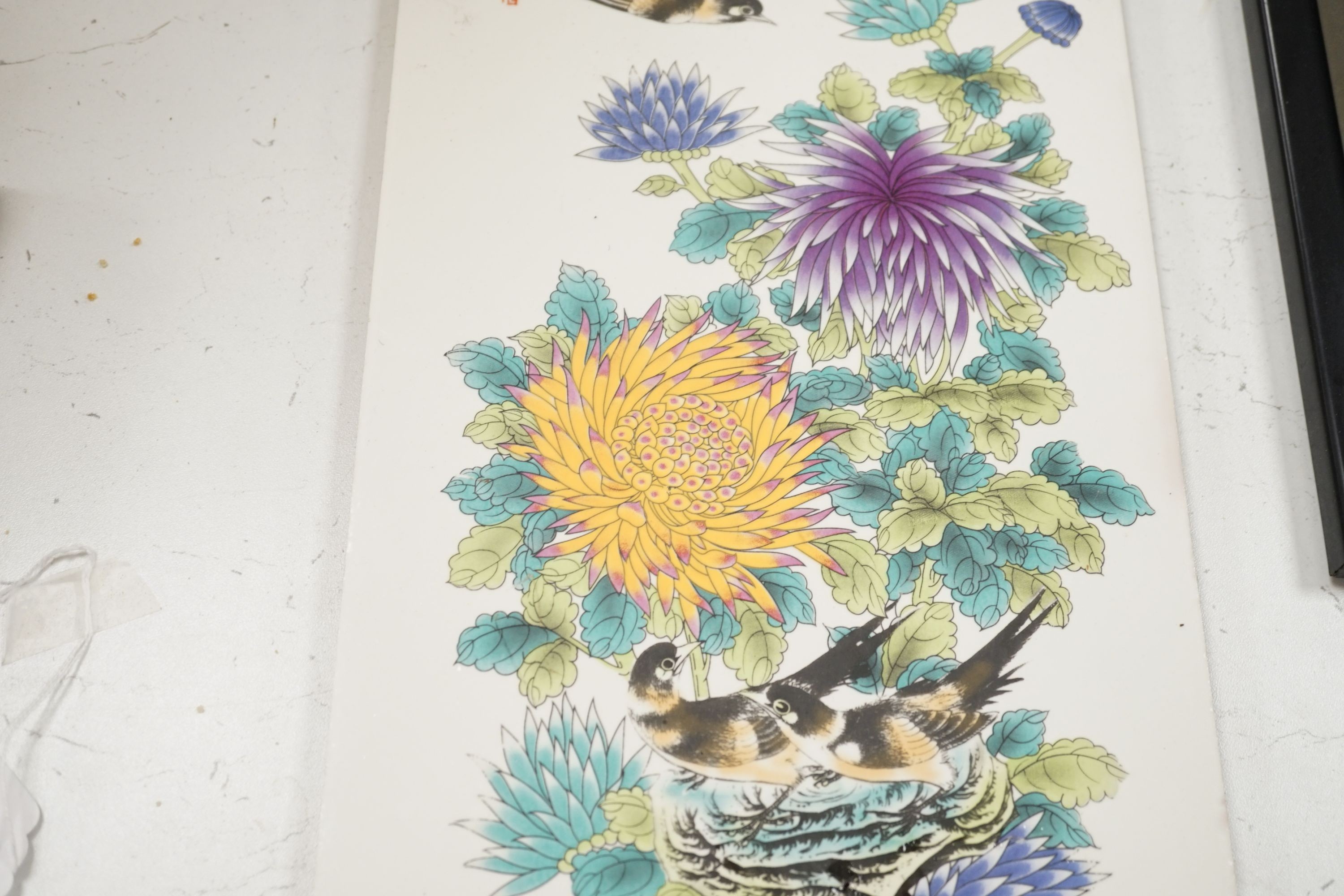 A Chinese enamelled tile, decorated with birds and flowers, 75 cms high x 22 cms wide.